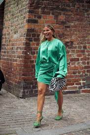 mujer con vestido verde y bolso cebra